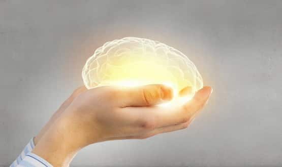 Hands cradling a glowing brain