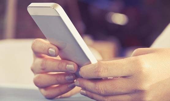 A woman's hands holding a smartphone